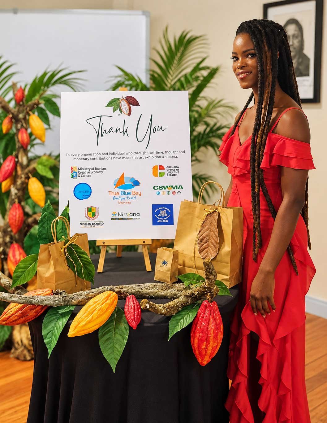 Rashida Isaac of RI Creations displaying handmade Grenadian cocoa-inspired artwork